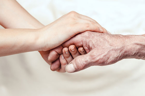 Child holding elder's hand